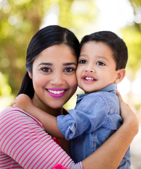 Mother holding infant after pediatric dentistry visit