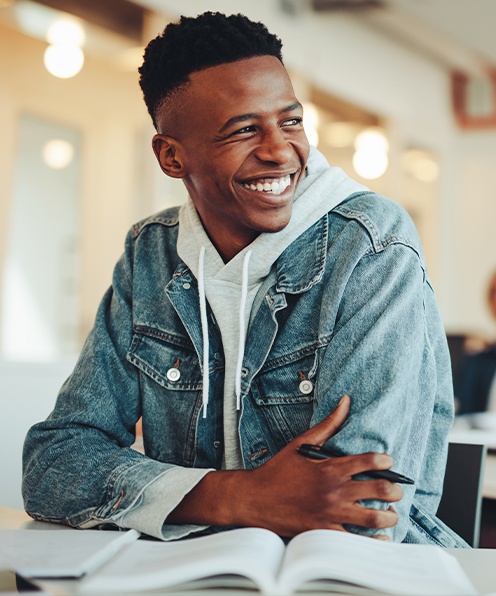 Young man smiling after cosmetic adolescent dentistry