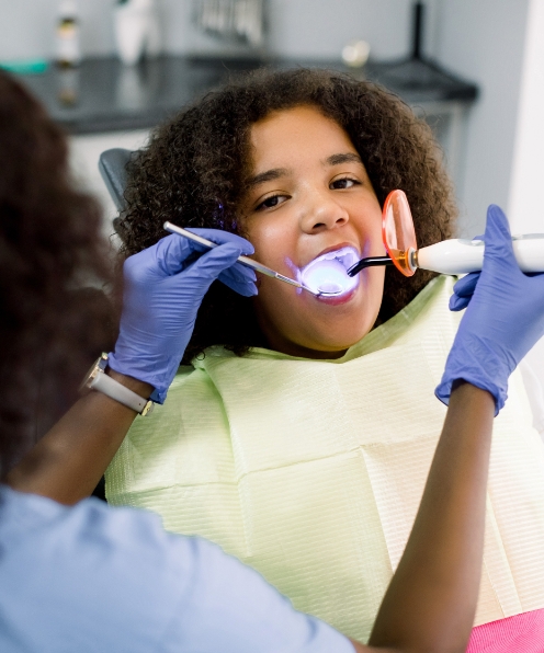 Child receiving protective dental sealants