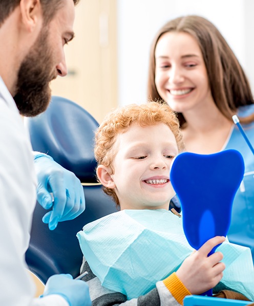Child smiling in preparation for a dental checkup and cleaning