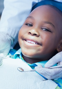 child giving thumbs up while in dental chair near Wheeling