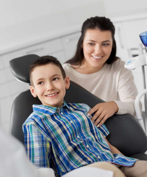 Mother and child discussing the cost of treating a child's dental emergency with the dentist