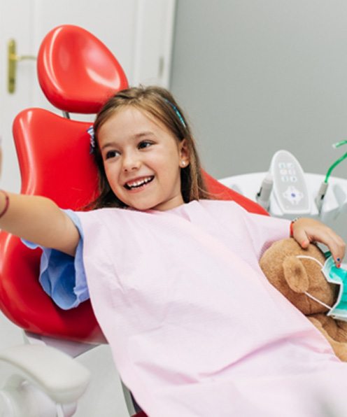 Little girl giving her dentist a high five