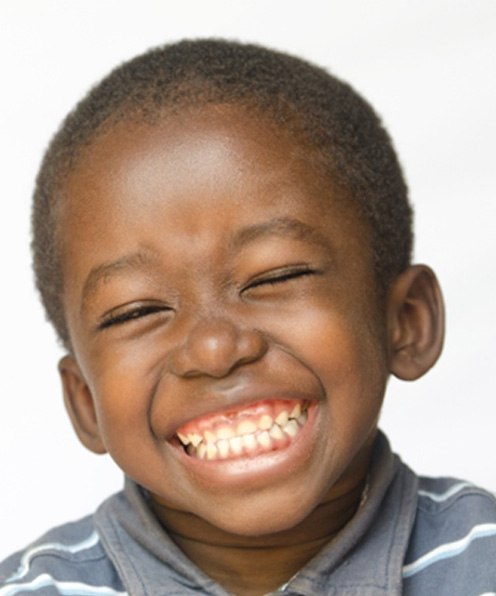 Close-up of little boy with striped shirt smiling