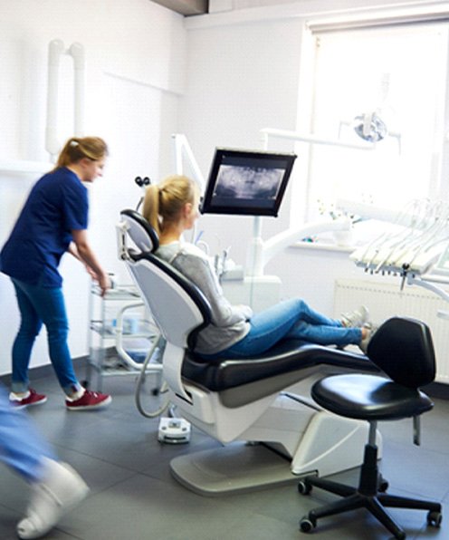 patient sitting in busy dental office