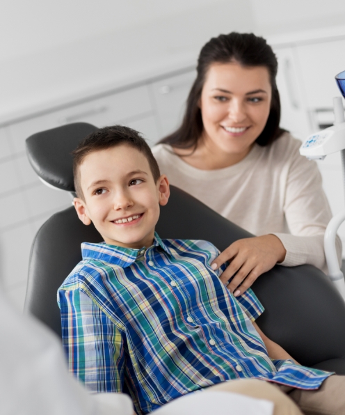 Young child smiling during tooth extraction visit