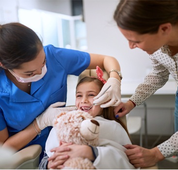 Child receiving preventive dentistry for children