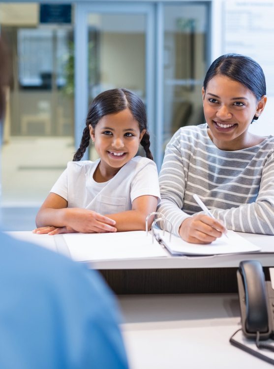 Mother and daughter checking in at pediatric dental office