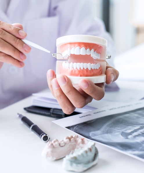 Dentist pointing to smile model