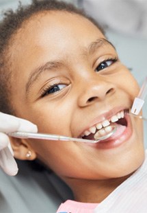 : young girl smiling at dentist office