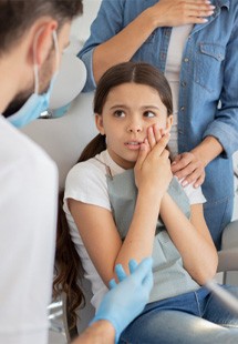 young girl with tooth pain