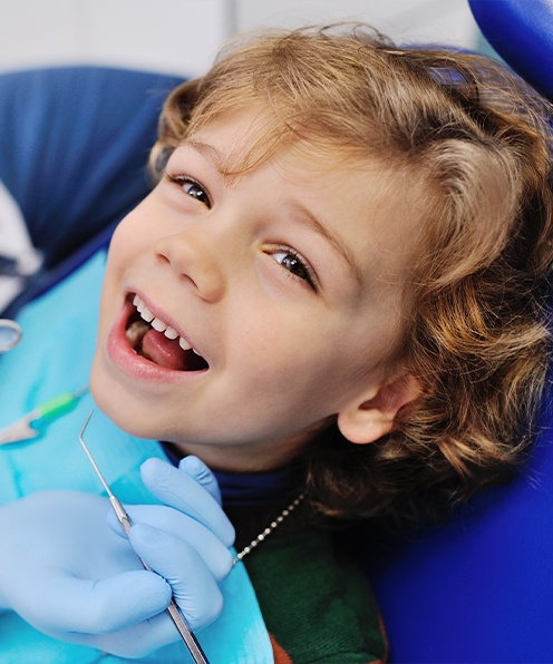Child smiling after tooth extractions