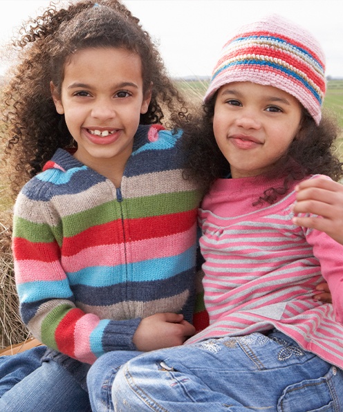 Two children smiling after orthodontic referrals for phase one treatment