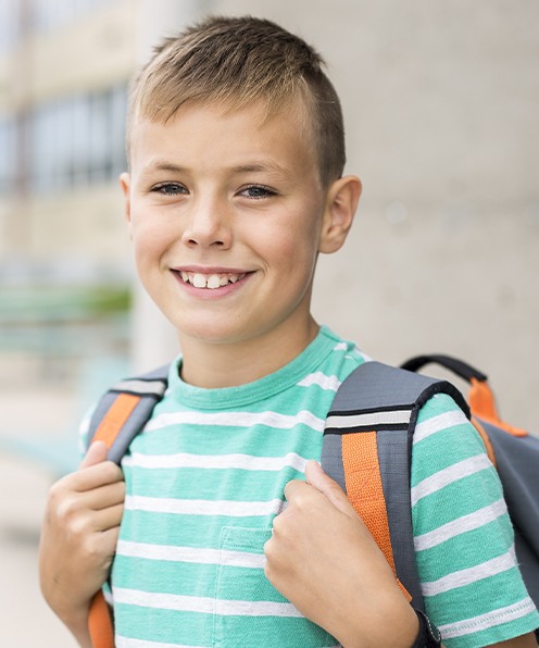 Young child smiling before phase two orthodontic treatment visit