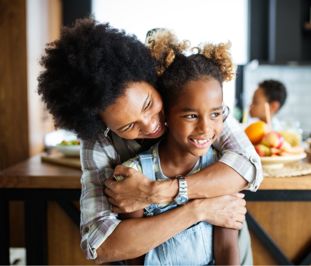 Mother hugging child after pediatric dentistry