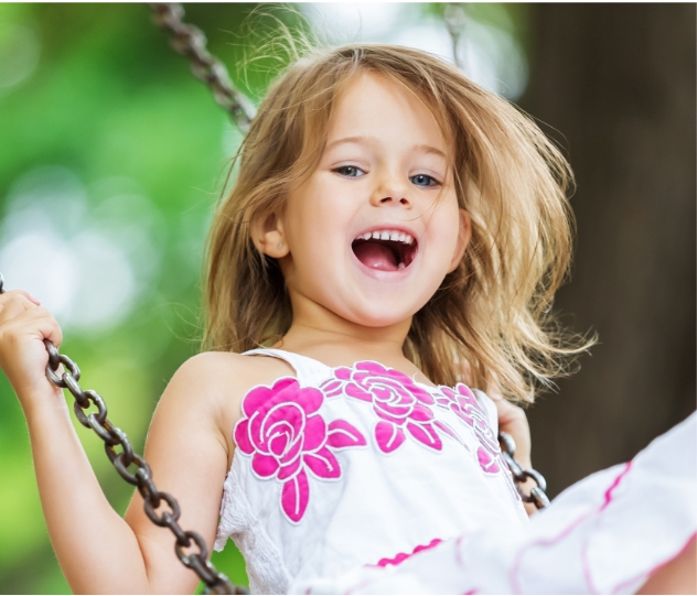 Young child smiling after adolescent dentistry visit