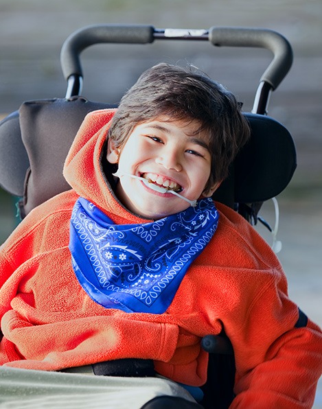 special needs child smiling while in chair