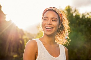 woman smiling while outside 