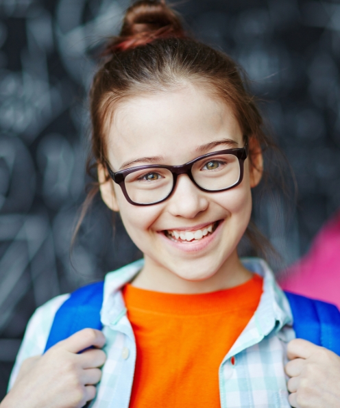 Young girl with healthy smile after dentistry for children