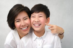 mom and young teen smiling without teeth whitening for kids