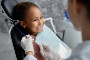 Young girl smiling at the dentist