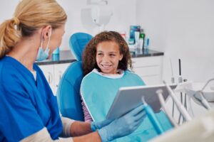 Child smiling in the dentist’s chair